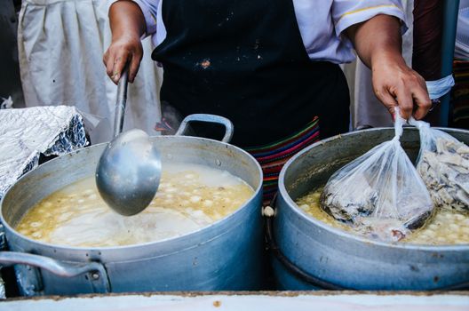 Peruvian food: Sopa criolla of caldo de mote in a large aluminum pot