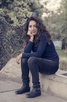 Portrait of a young woman enjoying and smiling in the park