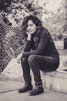 Portrait of a young woman enjoying and smiling in the park