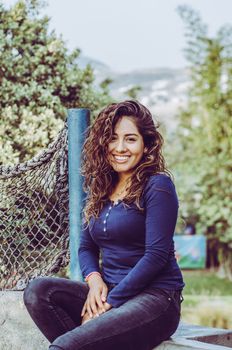 Portrait of a young woman enjoying and smiling in the park