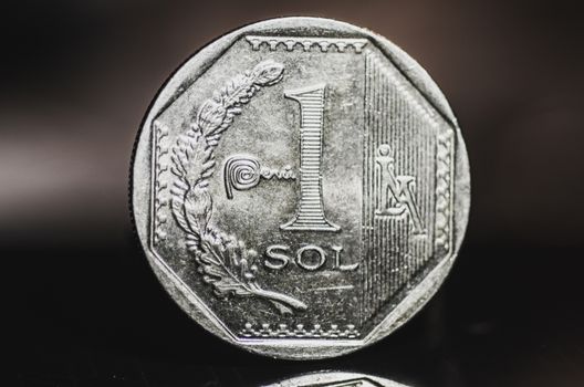 1 Peruvian nuevo sol coin isolated on black background