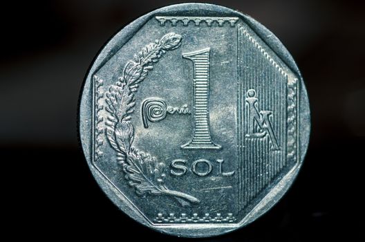 1 Peruvian nuevo sol coin isolated on black background