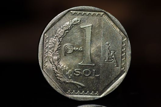 1 Peruvian nuevo sol coin isolated on black background