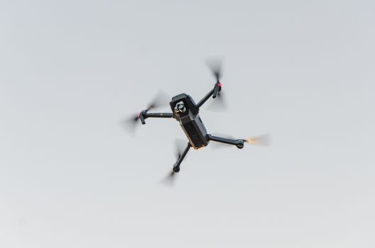drone quadcopter with digital camera in the air