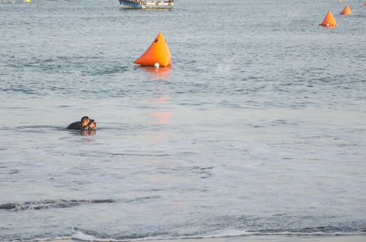 Photographer takes a photo of the fishing boat in the sea in Lima, Peru