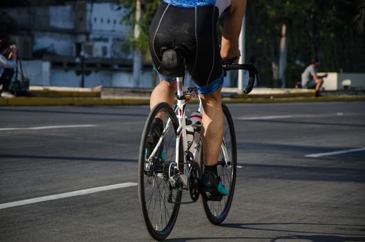 Back cyclist with sportswear on the road