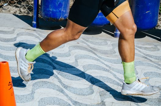 Sports background. Runner feet running on road closeup on shoe.