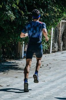 A man runner on the street doing exercises, image concept of sport and exercise