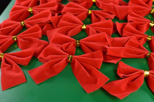 A full set of packaged decorative red bows used during the Christmas holiday season for dressing up the tree or gifts.