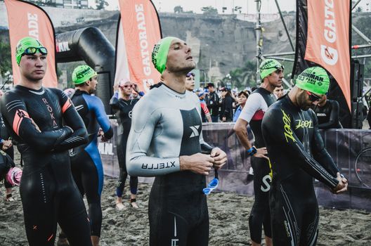 LIMA, PERU - APRIL 22th 2018: Ironman 70.3 . Athlete preparing for the competition and enter to swim