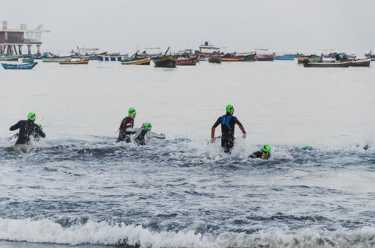 LIMA, PERU - APRIL 22th 2018: Ironman 70.3 . Starting for the swimming test of the athletes of the Ironman 70.3
