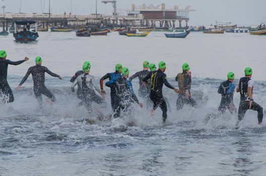 LIMA, PERU - APRIL 22th 2018: Ironman 70.3 . Starting for the swimming test of the athletes of the Ironman 70.3