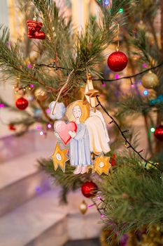 Decorated Christmas tree with toy angel in Orthodox church. Merry Christmas religious concept