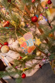 Decorated Christmas tree with toy angel in Orthodox church. Merry Christmas religious concept