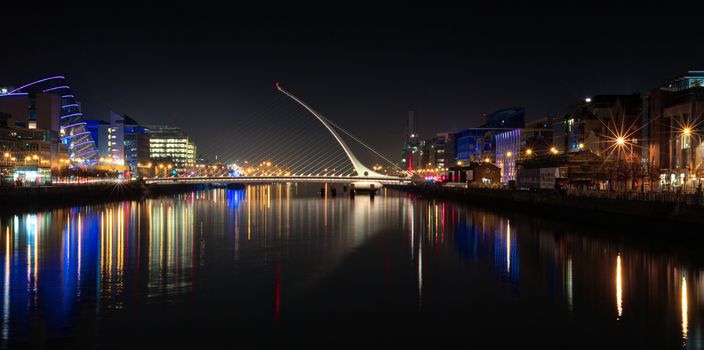 Dublin Ireland River Liffey at Night with harp bridge reflections
