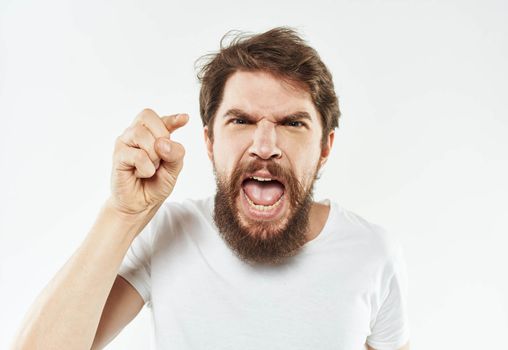 A man with a thick beard gestures irritably with his hands stress emotions. High quality photo