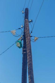 Electric pole with lamps and wires against Blue Sky.