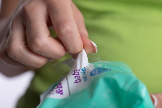 Closeup Hand picked a wet wipes from package - hygiene procedure and prevention of infectious diseases stock photo