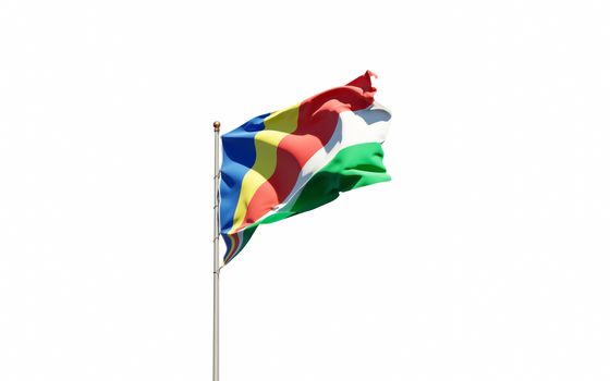 Beautiful national state flag of Seychelles fluttering at sky background. Low angle close-up Seychelles flag 3D artwork.