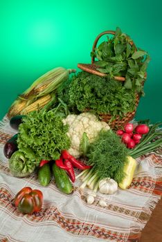 Wicker basket and vegetables on a studio background