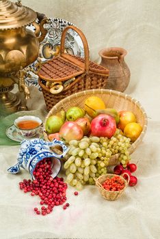 Russian traditional water boiler, flowers and berries on a studio background