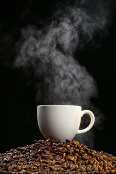 Cup of coffee with stesm on a studio background