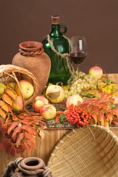 Bottle of wine and fruits on a studio background