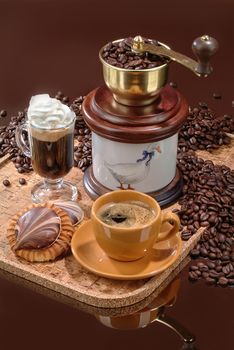 Coffee mill and cup on a glass background