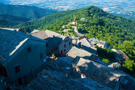 High angle view on a corsican village in the mountains with forest and sea in the background on a sunny day in summertime