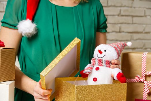 Gift wrapping for Christmas and New Year. Handmade. girl's hands with gift ribbon, twine, tape and present wrapped and packing concept