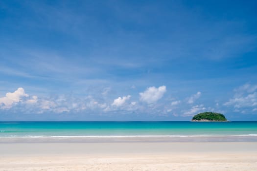 Tropical nature clean beach and white sand in summer season with sun light blue sky background.