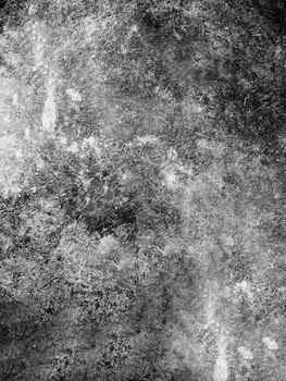 Stone base of the wall with a rough textured surface of dark color .Texture or background