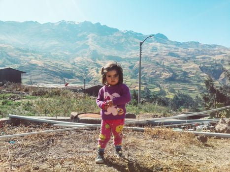 Portrait of a cute little girl in the mountains, in Canta north of the capital of Lima in Peru