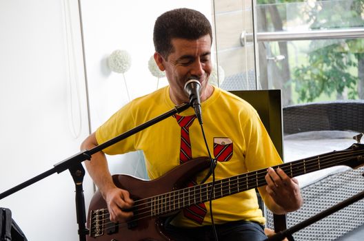 Handsome young musician playing the guitar and singing