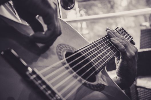Closed shot where you can see the artist's hands and guitar