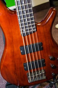 Beautiful guitar bass, under bright red color, blur background