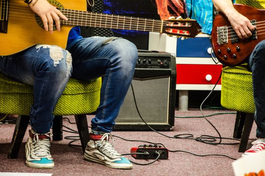 Close Up Of Man Playing Amplified Acoustic Guitar
