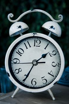 Old white vintage alarm clock, time concept