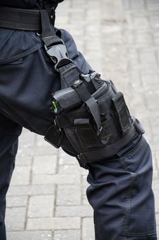 Leg of a policeman in which a firearm is found, concept of security