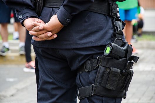 Leg of a policeman in which a firearm is found, concept of security