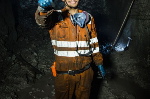 Miner smiling inside the mine, photography business concept