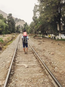 Father and daughter walking on the train tracks, father and daughter together