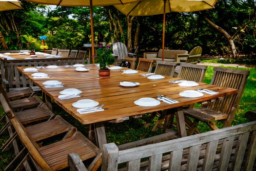 Decorated camping table with dishes on a sunny summer day