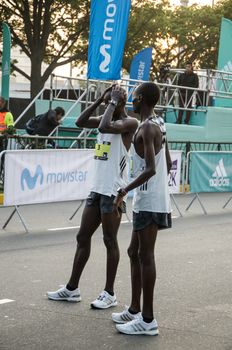 Lima, Peru - May 20th 2018: Marathon Lima 42k, sporting event that gathers athletes from all over the world. Elite athletes stretching before the marathon.