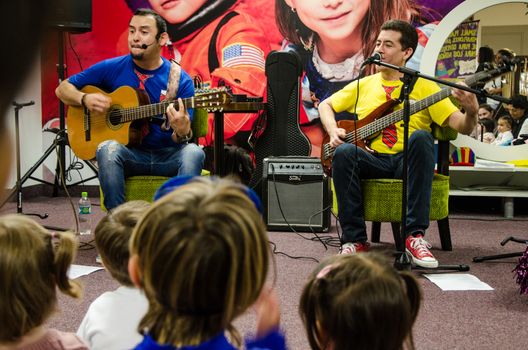 Lima, Peru - May 25th 2018: Musical Band for children Troly and El Lobito. The guys singing to children.