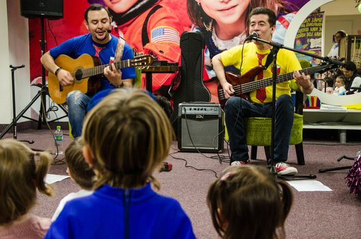 Lima, Peru - May 25th 2018: Musical Band for children Troly and El Lobito. The guys singing to children.