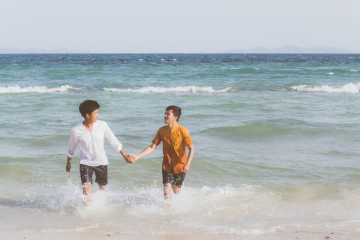 Homosexual portrait young asian couple running with cheerful together on beach in summer, asia gay going tourism for leisure and relax with happiness in vacation at sea, LGBT legal concept.