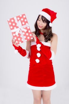 Beautiful portrait young asian woman happy holding red gift box with excited in xmas holiday isolated on white background, asia girl surprise and celebrating in festive Christmas and new year.