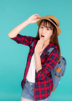 Beautiful portrait young asian woman smiling and surprise wearing travel summer fashion tourist in vacation isolated on blue background, girl shocked expression and emotion, holiday concept.