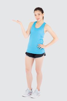 Beautiful portrait young asian woman in sport clothes with satisfied and confident presenting and show something isolated on white background, asia girl exercise for fit with health concept.